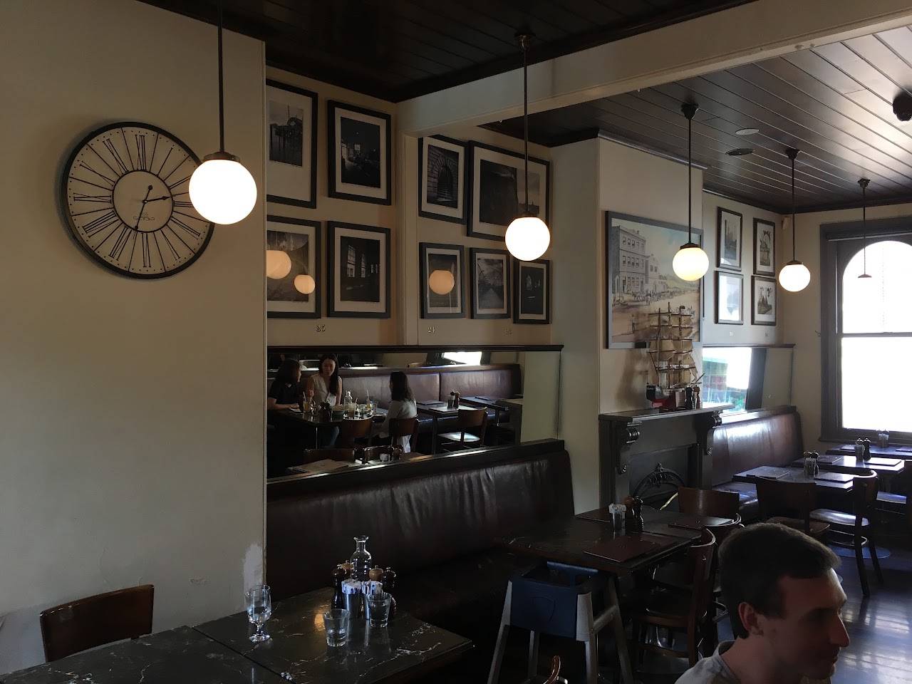The Rocks Cafe dining room with framed art and pendant lights